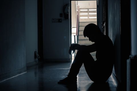 silhouette of man sitting alone