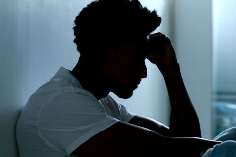 person sitting on floor going through gabapentin withdrawal